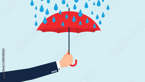 Businessman hand holding a red umbrella to provide protection from falling blue raindrops against a light blue background for safety concepts.
