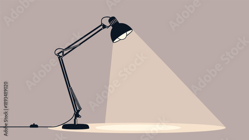 Classic black adjustable desk lamp illuminates a circular area on the floor with a bright cone of light against a neutral wall.