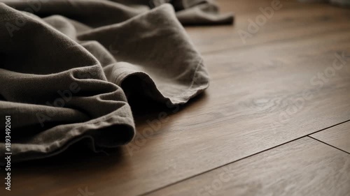 Warm brown natural wood floor background with soft fabric texture. An emotional and cozy scene embracing minimalism in interior design for peaceful, comfortable home