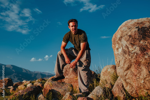Young man resting on rocks portrait