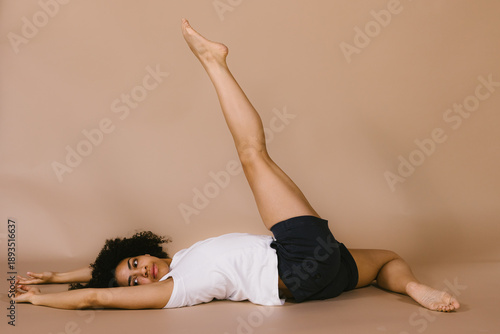 Black woman dancer on back with leg extension
