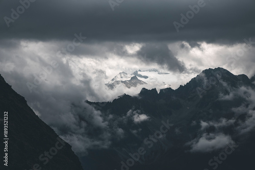 dark clouds and mist by the mountains