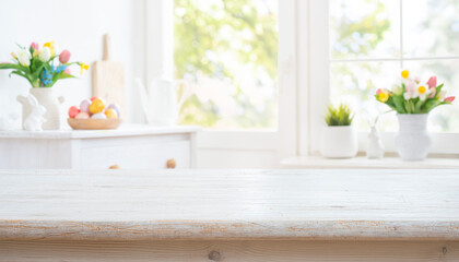 Empty wooden table for product display on decorated for Easter celebration blurred kitchen background