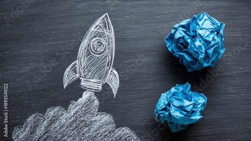 Chalkboard Drawing of Rocket Launching with Crumpled Paper Concept for Business Innovation and Startup