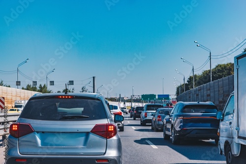 Obraz na płótnie Traffic Jam on a Sunny Day: Cars Stuck on a Busy Highway with Clear Blue Skies A