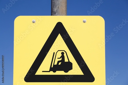 Caution forklift traffic sign on a pole