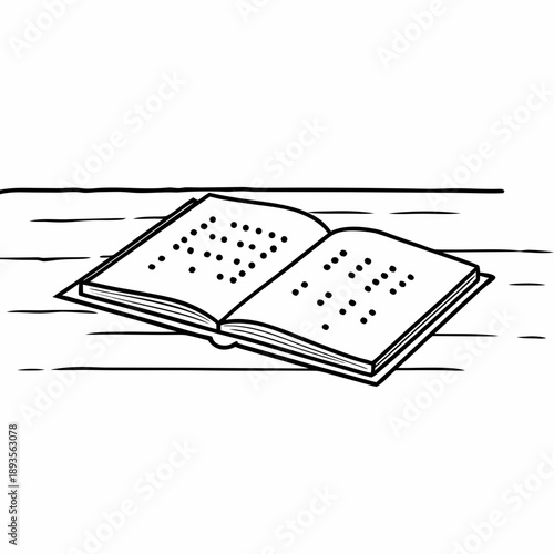Open book with Braille text on wooden table surface  