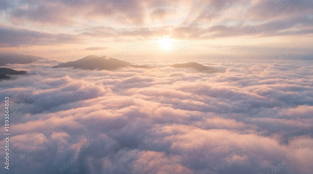 Obraz premium Sunrise over mountains and clouds with soft light and mist in the sky
