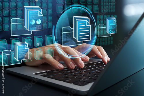 Document and knowledge management systems. Automated text data classification. Businessman using laptop computer to access database.