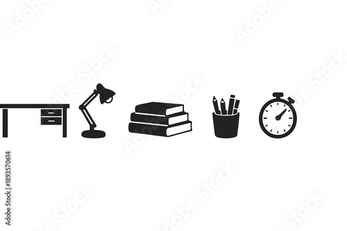 Desk setup including lamp, books, stationery, and timer in a work environment during daytime