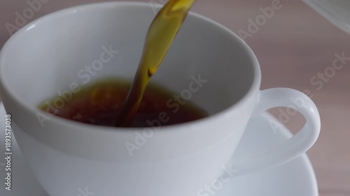 Pouring coffee into a white cup