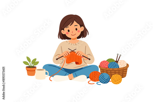 Woman knits with colorful yarn at home while sitting on the floor, surrounded by plants, a cup of tea, and a basket of yarn in the afternoon