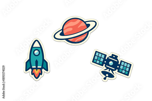 Stickers showing a rocket, a planet with rings, and a satellite are placed on a white background in an arrangement that showcases space themes