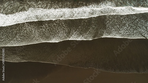 Wallpaper Mural Abstract aerial lines of ocean waves on dark sand beach in Costa Rica at overcast dusk. Torontodigital.ca