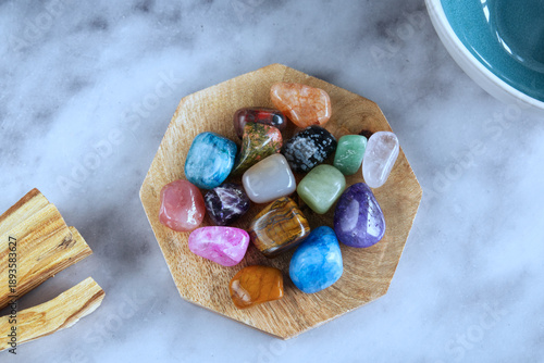 Colorful Healing Crystals on Wooden Plate, Flat Lay on Marble Background