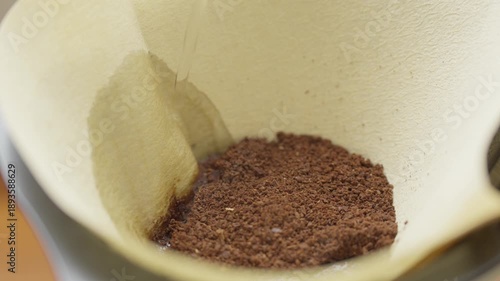 Pour hot water over coffee grounds