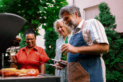 Senior Family Members Talking Together at Outdoor Dinner Party