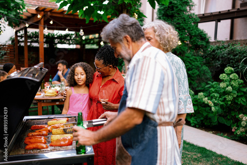 Konstfotografi Multigenerational Family Enjoying Time Together by Backyard Grill