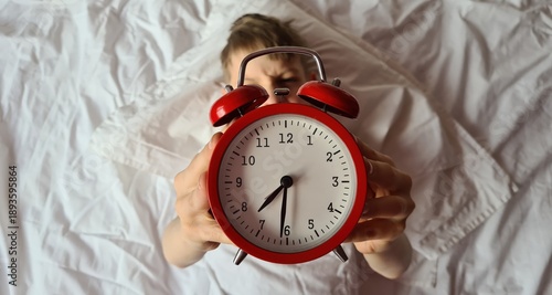 Wallpaper Mural Boy child lying in bed holding red alarm clock Torontodigital.ca