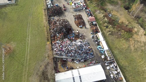 Large junkyard with rusty iron and steel piles