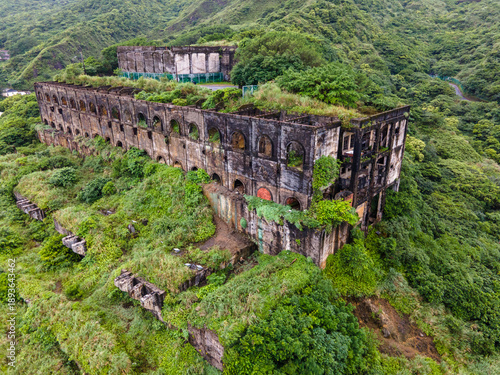 Aerial close-up of the upper-level remains of the 13 Levels gold and copper smelters near Jiufen, Taiwan, highlighting decaying concrete structures, geometric forms, and dramatic industrial heritage t