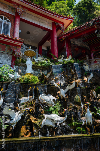 Decorative crane statues stand on a fountain at Futian Temple on Lion’s Head Mountain, symbolizing longevity and harmony within a serene Taiwanese religious setting.

