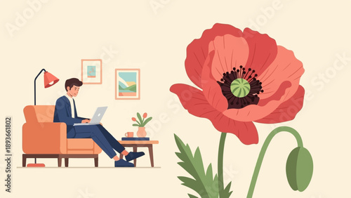 Man in suit working on laptop in armchair next to a large red poppy