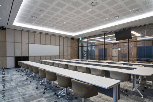 Professional conference room with long tables and chairs