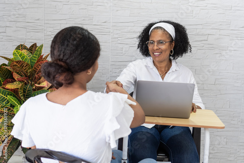 Student celebrating university acceptance shaking mentor's hand
