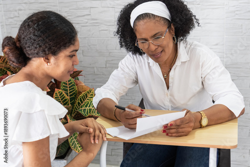 Mentor guiding student reviewing university acceptance letter
