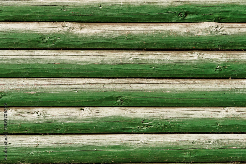 Obraz premium background of old weathered and cracked boards with peeling paint of green color