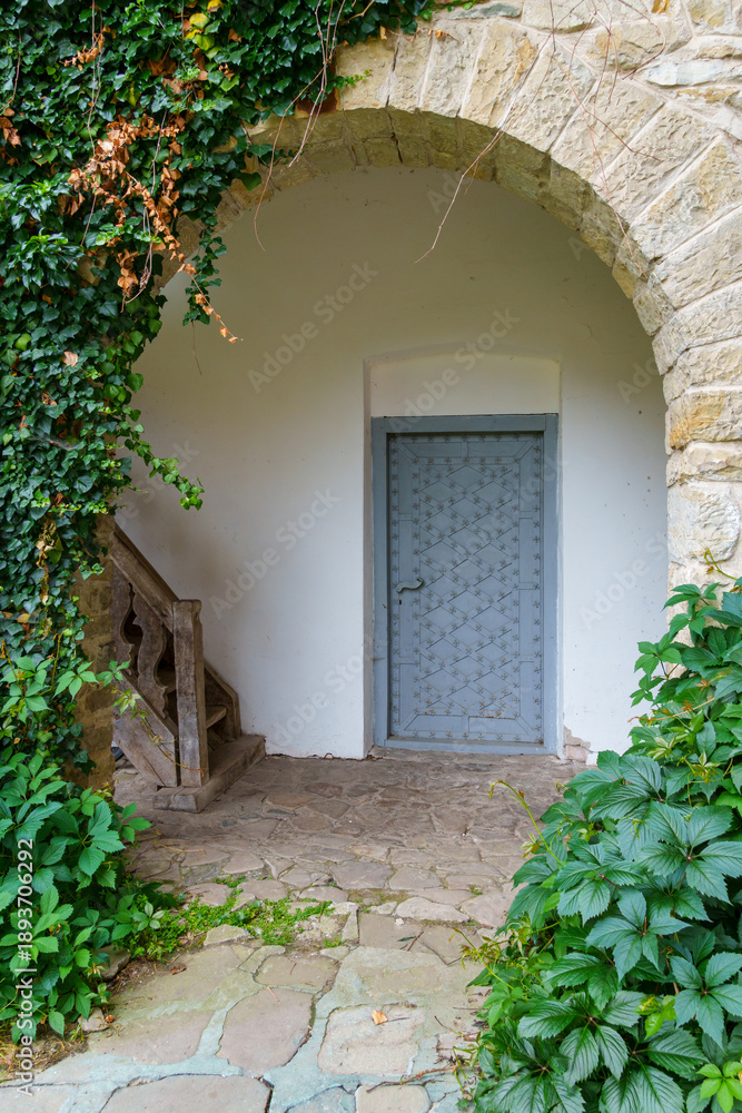 Fototapeta premium close up of architectural details, old stone wall with arch and door