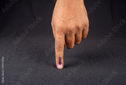 Indian voter hand displaying indelible ink mark on index finger after casting vote in election
