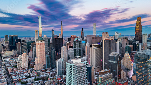 Midtown Manhattan skyline at colorful sunset. Aerial view of Midtown Manhattan skyscrapers under dramatic sunset sky. © Vadim