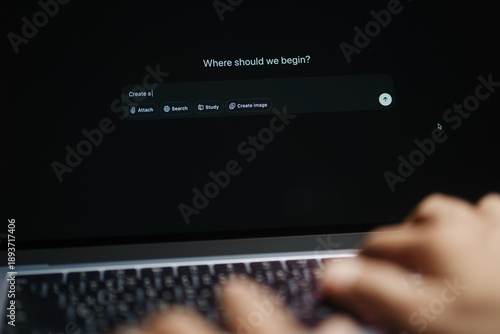 The hands of a man using a laptop or smartphone to operate artificial intelligence (AI), inputting commands and interacting with AI, AI assistants, chatbots, chat GPT.