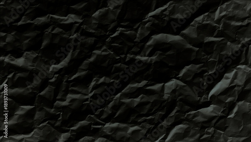 Black crumpled paper texture background closeup