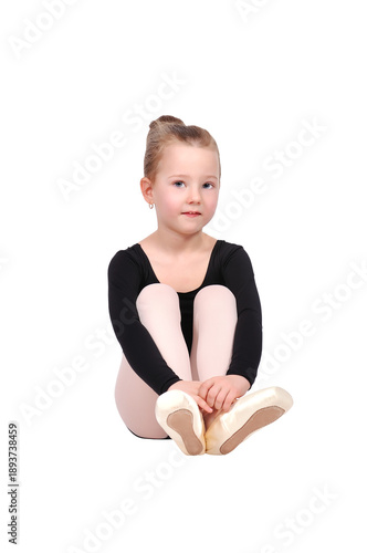 Little girl sitting in ballet position