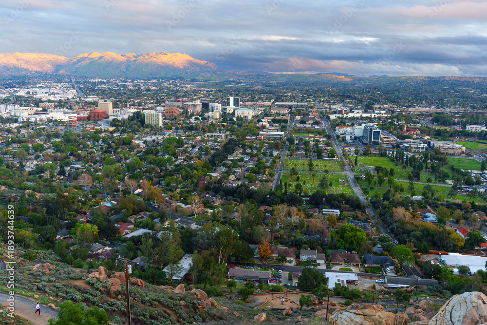 Fototapeta premium Panoramic Vista Of Riverside California With Distant Mountains Bathed In Golden Light