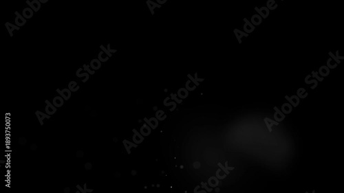 Floating bokeh light spots and round dust debris in a dark room