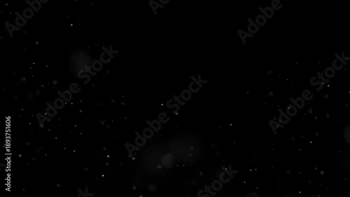 White ash particles drifting across a black background.