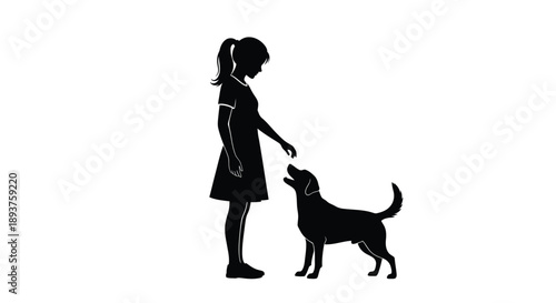 Silhouette of a young girl offering a treat to a happy dog