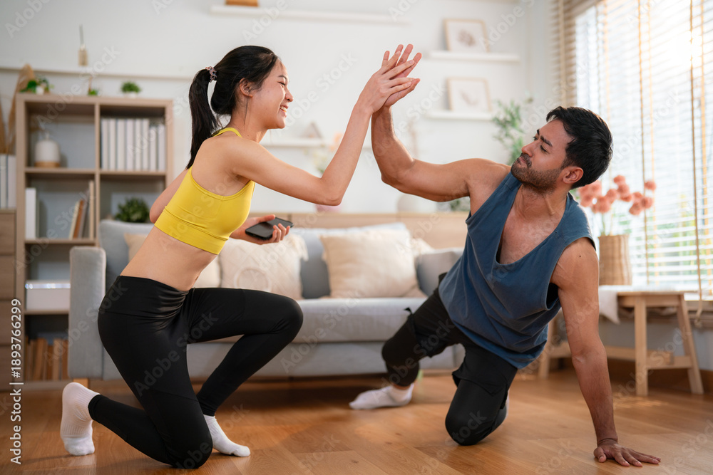 Obraz premium Couple celebrating workout success with high five