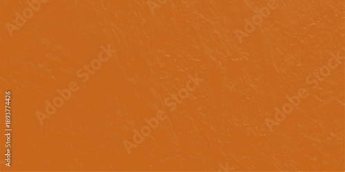 A rough orange wall texture with a vintage grunge pattern on a dirty aged paper surface creates a blank cardboard material backdrop for art and design backgrounds