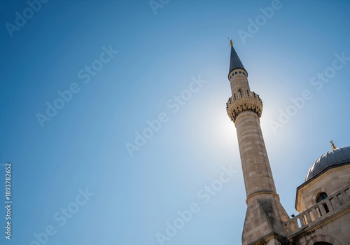 Wallpaper Mural Minaret against a bright sun and blue sky, architectural detail Torontodigital.ca