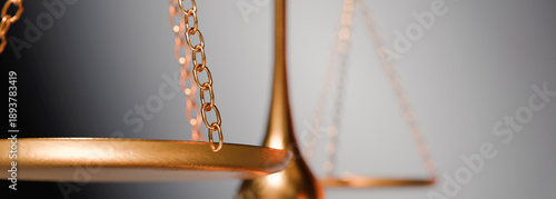 Photography The gleaming golden balance scale, a symbol of justice and legal proceedings, is