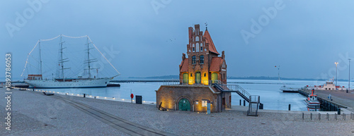 Photos Panoramic view of Stralsund harbor with historic pilot house and sailing ship Go