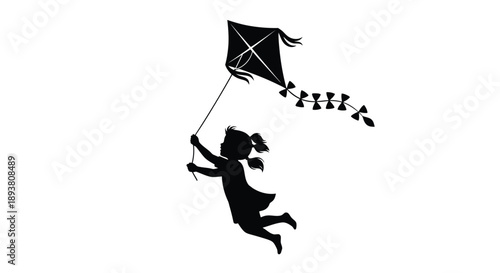 Silhouette of a child flying a diamond kite with a trailing ribbon