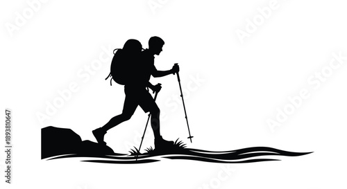 Silhouette of a hiker with backpack and walking stick on a hill