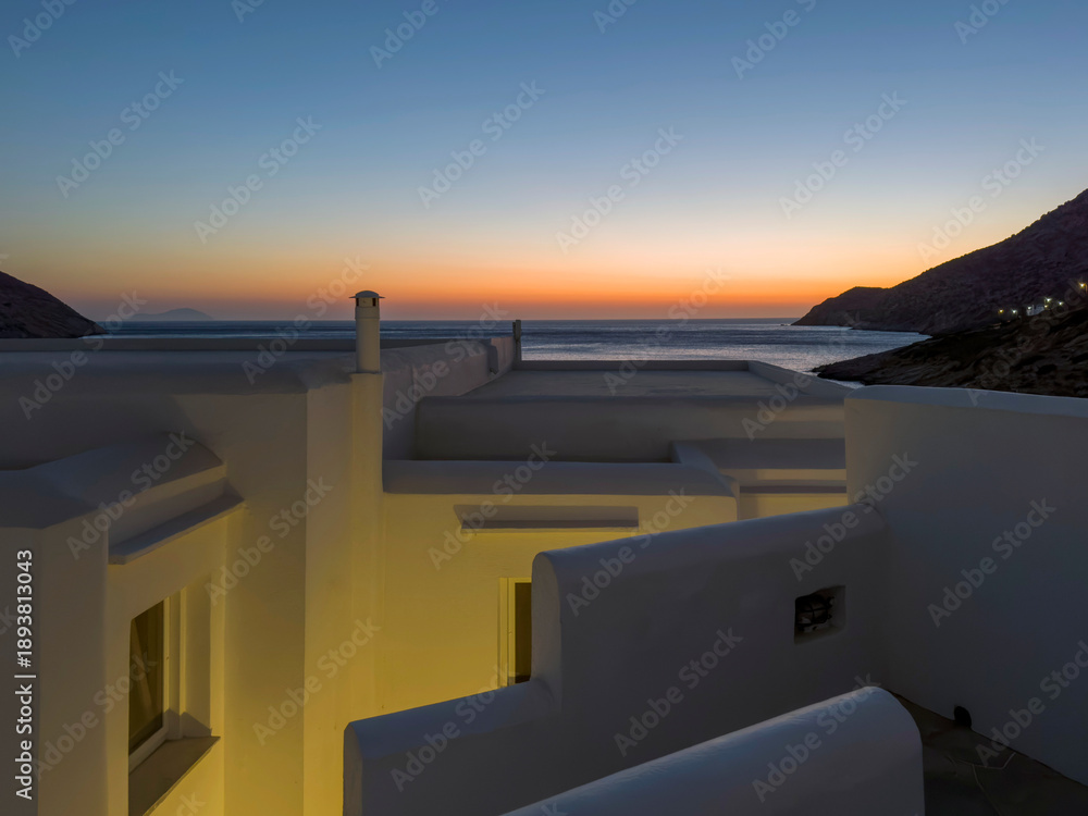 Fototapeta Cycladic house rooftops at sunset