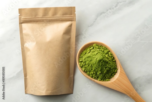 Organic green powder in kraft pouch with wooden spoon